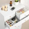 A white dresser with open drawers filled with cosmetics and decorative items. Náhľad obrázku produktu