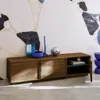 A wooden TV cabinet with decorative items on top, set against a patterned wall. Anteprima dell’immagine prodotto