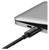 A close-up shot of a black USB-C cable plugged into a silver laptop. Anteprima dell’immagine prodotto