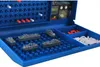 A close-up shot of a Battleship board game, showing the blue game board with gray ship pieces and red and white pegs. Produktbild-Vorschau