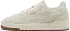 A side view of a white Puma sneaker with a brown sole. Produktbild-Vorschau