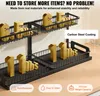 A two-tier black metal under-sink organizer with gold weights on each shelf to demonstrate weight capacity. Náhled obrázku produktu