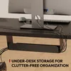 A close-up view of an under-desk cable management system attached to a desk, with cables neatly organized within it. Voir les images du produit