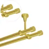 A close-up view of a double curtain rod system in a brass gold finish, mounted from the ceiling. Produktbild-Vorschau