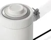 A close-up view of the top of a white filter pump with a gray ring and a white knob. A white ribbed hose is attached to the side of the pump. Produktbild-Vorschau