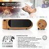 A woman is waking up in bed next to a digital radio alarm clock with a projector. Produktbild-Vorschau