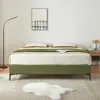 A bedroom scene with a bed, nightstand, and floor lamp. Produktbild-Vorschau