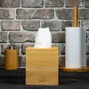 A bamboo tissue box and a bamboo paper towel holder are displayed against a brick wall. Náhled obrázku produktu