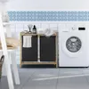 A laundry room scene with a washing machine and a two-compartment laundry basket. Náhled obrázku produktu
