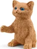 A small, brown, toy cat figurine with blue eyes is shown from the front, sitting on a white background. Anteprima dell’immagine prodotto