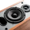 A close-up view of a speaker driver and tweeter on a speaker cabinet. Produktbild-Vorschau