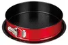 A round cake pan with a red exterior and black interior, shown from a slightly elevated side angle. Produktbild-Vorschau