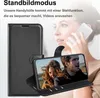 A woman is holding a phone in a black wallet case, which is propped up to display a video of a couple. Produktbild-Vorschau