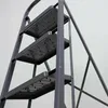 Close-up view of a gray metal stepladder with four steps. Náhled obrázku produktu