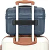 A close-up view of a blue travel case stacked on top of a white suitcase, secured by a black strap. Anteprima dell’immagine prodotto