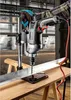 A person is using a drill press to drill into a metal beam. Náhľad obrázku produktu