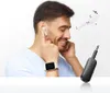A man is using wireless earbuds and holding a small black device with a jack plug. Anteprima dell’immagine prodotto