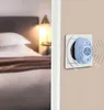 A device plugged into a wall socket in a bedroom setting. Produktbild-Vorschau