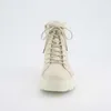 A front view of a beige lace-up boot with a white sole and fur trim. Produktbild-Vorschau