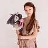 A young girl holds a hobby horse with a pink ribbon and a number '1' medal. Produktbild-Vorschau