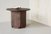 A round, dark wood side table with a decorative white bowl on top, set against a wall with marble-like texture. Produktbild-Vorschau