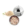 A stainless steel rice ball infuser is shown next to a pile of rice and a small bowl of rice. Náhľad obrázku produktu
