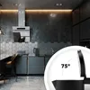 A modern kitchen with a sleek design, featuring a range hood, hexagonal backsplash tiles, and a close-up inset of a kettle lid. Produktbild-Vorschau