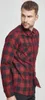 A man wearing a red and black checkered flannel shirt. Produktbild-Vorschau
