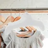 Inflatable hangers on a closet rod with clothes. Produktbild-Vorschau