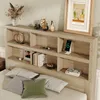 A bed with a bookshelf headboard, decorated with various items. Produktbild-Vorschau