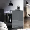 A modern bedroom scene featuring a nightstand with a drawer and an open shelf, a bedside lamp, and a clock. Produktbild-Vorschau