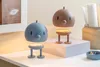 Two cartoon-like lamps with spring-like bases are displayed on a desk. Produktbild-Vorschau