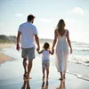 A family walking on the beach at sunset. Produktbild-Vorschau