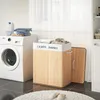 A laundry room scene with a washing machine and a bamboo laundry basket. Produktbild-Vorschau