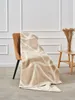 A blanket draped over a chair in a room. Anteprima dell’immagine prodotto