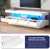 A white TV stand with blue LED lighting, showing open drawers and a close-up of a drawer mechanism with text overlay. Náhľad obrázku produktu