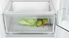 A close-up view of a refrigerator's crisper drawer containing a napa cabbage, two pears, and two limes. The drawer is labeled 'Fresh' and has a diagram indicating it's for 'fruit & vegetables'. Voir les images du produit