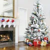 A decorated Christmas tree with presents underneath, next to a fireplace with stockings hung. Produktbild-Vorschau