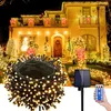 A house decorated with Christmas lights at night. Produktbild-Vorschau