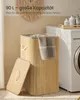 A bamboo laundry basket with a lid is shown next to a washing machine in a bathroom or laundry room setting. Produktbild-Vorschau