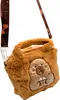 A plush capybara-shaped handbag with a strap. Produktbild-Vorschau