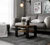 A modern living room scene with a grey sofa, brick wall, and a coffee table. Produktbild-Vorschau