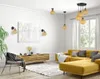 A modern living room with a yellow sectional sofa, a wooden media console, and a black accent chair. Náhled obrázku produktu