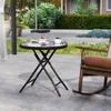 A round folding table with a cake and blueberries on it, placed on a patio next to a rocking chair. Podgląd zdjęcia produktu