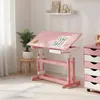 A pink children's desk with a drawing on it, placed in a room with a plant and a chest of drawers. Produktbild-Vorschau