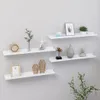 Four white wall shelves are mounted on a light gray wall, decorated with various items. Voir les images du produit