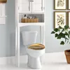 A white toilet with a decorative seat cover is shown in a bathroom setting. Produktbild-Vorschau