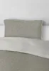 A close-up view of a pillow and duvet cover on a bed. Produktbild-Vorschau