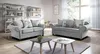 A living room setting with two sofas and coffee tables.