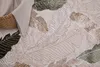 A close-up view of a rug with a leaf pattern. Produktbild-Vorschau